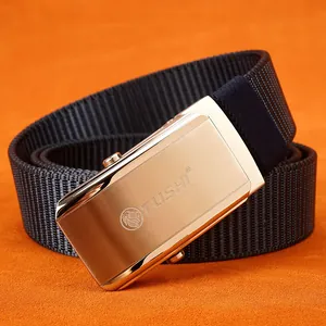 Navy blue nylon tactical belt with brushed golden lion buckle on orange backdrop