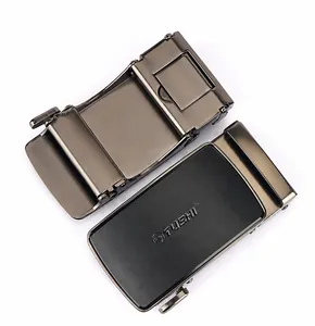 Detail of the gunmetal zinc alloy automatic buckle featuring TUSHI brand logo and mechanism