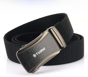 Close-up of matte dark gray automatic buckle with lion logo and black woven nylon strap