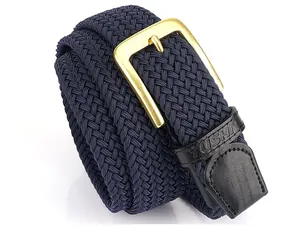 Detail eines elastischen Webgürtels in Marineblau mit Messingschnalle und Leder