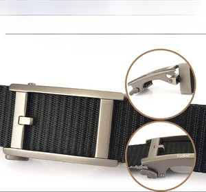 Detail of the rotating silver metal buckle and durable nylon fabric on men's tactical belt