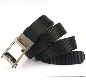 Detail of a thick black nylon belt featuring a brushed gunmetal automatic buckle