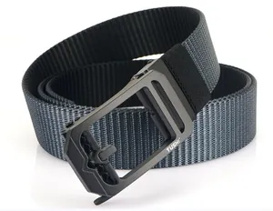 Detail of grey hollow metal buckle and textured nylon webbing on men's tactical belt