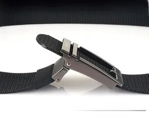 Close-up of gun-grey metal buckle and durable black nylon belt with automatic lock mechanism