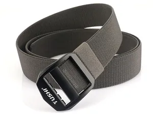 Close-up of black matte metal buckle with TUSHI logo and dark green nylon weave texture