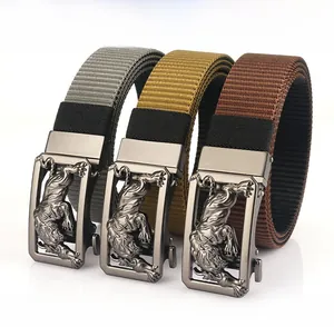 Close-up of three nylon belts with alloy tiger head buckles and rotating mechanism