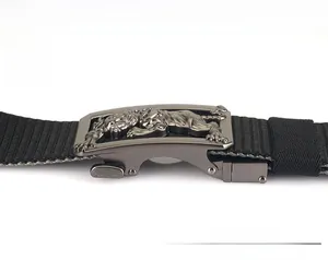 Detail of metal buckle featuring an embossed tiger motif on a black nylon belt