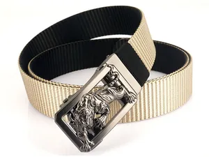 Macro detail of 3D tiger embossed metal buckle on dual-sided woven nylon tactical belt