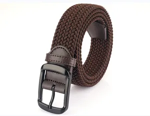 Close-up of dark coffee elastic woven belt with matte black metal pin buckle and leather detail