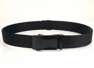 Detail of black nylon woven belt with matte black alloy automatic buckle on white surface