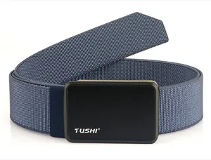 Detail of tactical nylon belt showing the TUSHI brand logo on a brushed metal buckle