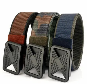 Detail view of woven nylon belts in brown, camo, and blue with plastic press buckles