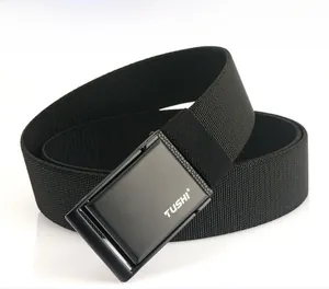 Detail view of the black matte metal buckle with TUSHI engraving on nylon canvas belt