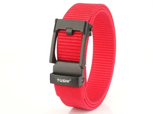 Detail of red nylon belt with matte black automatic buckle and textured weave pattern