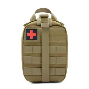 Close-up of tactical medical pouch in coyote brown with MOLLE straps and red cross patch
