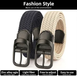Macro detail of navy and beige elastic woven belts with matte black zinc alloy pin buckles