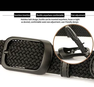 Detail of black elastic woven belt with matte metal buckle showing texture and pin design