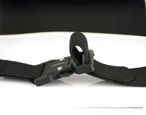 Detail view of tactical belt buckle with adjustable nylon strap and metal rivets