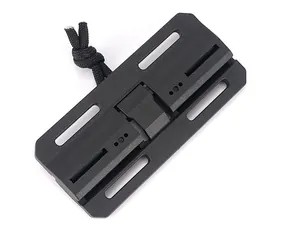 Macro shot of black plastic tactical buckle with mounting holes and nylon paracord loop