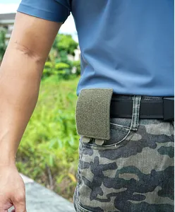 Tactical green nylon waist pouch with velcro closure mounted on belt for outdoor use