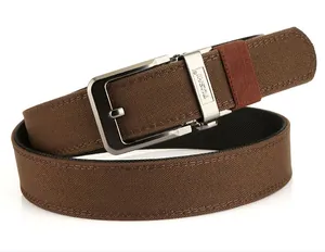 Detail of brown woven canvas belt with silver brushed metal buckle and red loop