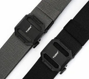 Detail of grey and black nylon tactical belts with matte textured TUSHI logo buckle