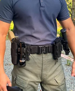 Tactical nylon belt detail with quick-release metal buckle and modular accessory pouches