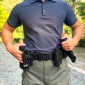 Detail of military nylon tactical belt with metal buckle, holster, and pouch attachments