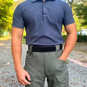 Tactical nylon belt set with alloy buckle on green cargo pants and navy polo shirt