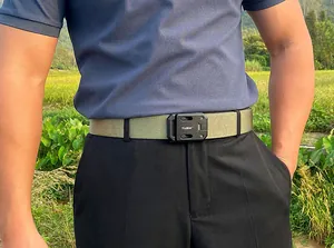 Close-up of tactical nylon belt with metal quick-release buckle worn in outdoor setting