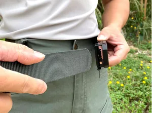 Close-up of durable dark green tactical nylon belt buckle during outdoor usage