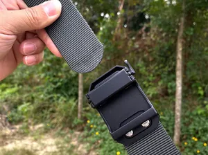 Close-up of tactical nylon belt with matte black quick-release buckle in outdoor setting