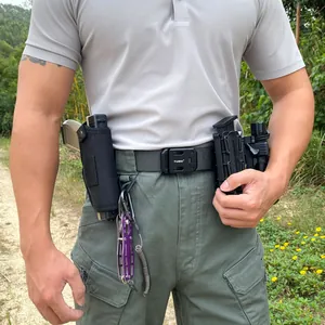 Tactical nylon belt detail showing quick-release buckle and mounted outdoor gear