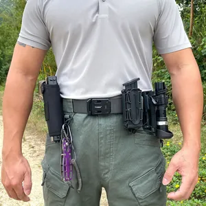 Tactical nylon belt with quick-release buckle, multi-tool, and flashlight in outdoor setting