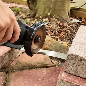 Cordless angle grinder cutting metal sheet with sparks in outdoor tactical setting