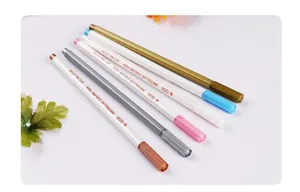 Detail of six STA metallic color markers Art.No.3330 on a minimalist desk surface