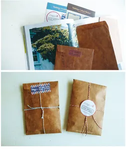 Detail showing vintage kraft paper envelopes with airmail stickers and rustic twine binding