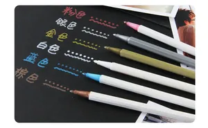 Macro detail of 6-color metallic markers showing vibrant ink coverage on black paper