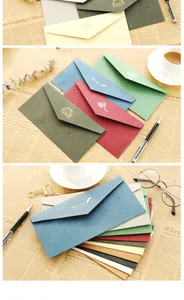 Macro view of vintage DL envelopes in various colors with elegant gold foil lettering