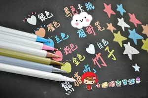Fine tip metallic paint markers writing vibrant star patterns on black cardstock