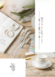 Macro shot of vintage washi tape set on wooden table with journal and tea cup decoration