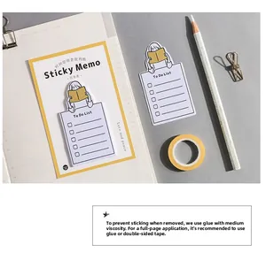 Detailed view of girl-shaped sticky memo and yellow to-do list for planners