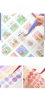 Macro detail of macaron color craft tweezers applying decorative planner stickers