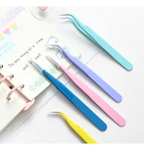 Macro view of macaron-colored stainless steel tweezers set with straight and curved tips