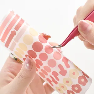 Colorful macaron stickers set with pink stainless steel tweezers on white background