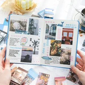 Aesthetic scrapbooking kit with blue grid notebook and vintage collage materials