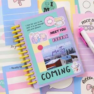 Pastel purple spiral notebook with cute dog stickers and aesthetic scenery cover design