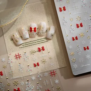 5D embossed Christmas nail stickers with gold bow and snowflake patterns on fake nails
