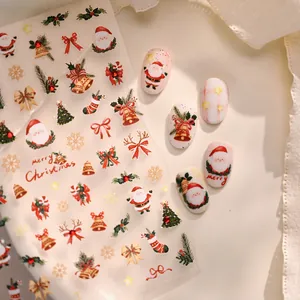 Cartoon Christmas nail art stickers set featuring Santa and trees on white false nails