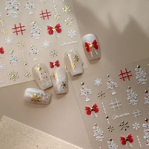 Christmas nail stickers with 3D snowflakes, bows, and trees on elegant neutral background
